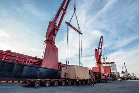heavy lift cargo handle by the professional teamwork to locate the package from the ship crane onto...