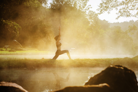 woman yoga pratice in hot spring water area with natural hot stream water for healthy and metitation stable mindの写真素材