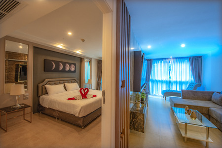 two tone bedroom and living room in an interior condominium living in the cityの写真素材