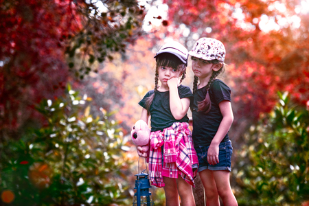 twin girls lost the way in forest, fear and worry for the evening attack at darkess of the nightの写真素材