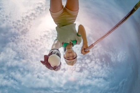 bottom view of golf ball in hand of woman takes from hole away to start tee off againの写真素材