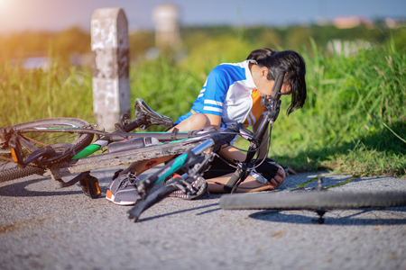 leg and feet of cyclist in hurt and injured after accident clashed, with wound and bleeding of blood flow on the surface of street roadの写真素材