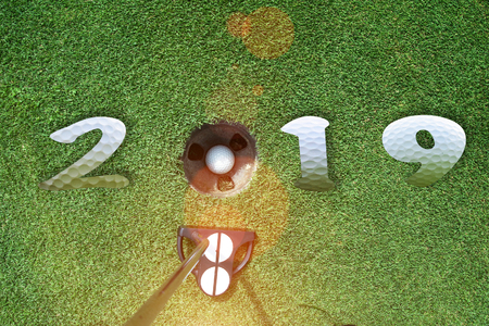 incoming year 2019, prepare by putting of golfer on the green,  golfball is ready dropped in hole of new year success, Happy new year and merry Christmas on golf courseの写真素材