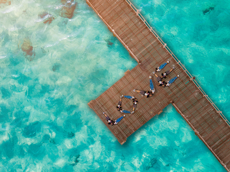 aerial top view of couple lover create symbol of word âLOVEâ on the wooden pier bridge, roman in vacation holidays and valentine day CONCEPTの写真素材