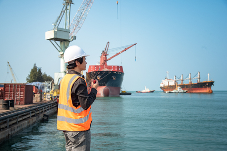 loading master, stevedore in charge on the loading discharging operation in port terminal, sea transportation working in portの写真素材
