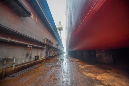 side walk way of the floating dock terminal and bottom layer of the commcercial ship sitting on the...