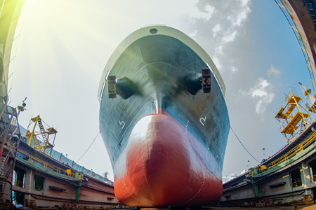 bulk head of the commercial ship sitting on the supporter in floating dry dock yardの写真素材