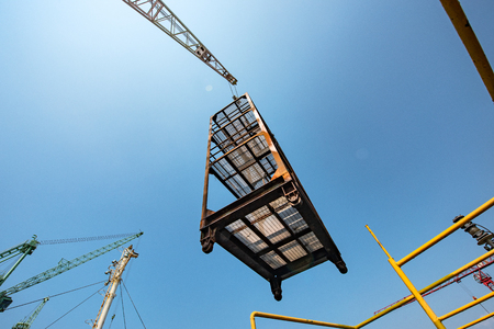 scaffolding lifting by the gantry crane by order of the stevedore or engineering, loading master, working on high level platform at risk of handle, handling good or equipments in high dangerousの写真素材