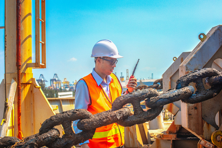 motorman or ship crew on duty of prepare the ship in drop anchorage the ship in port for safety, security berthing in port under command of the master or captain and port controlの写真素材