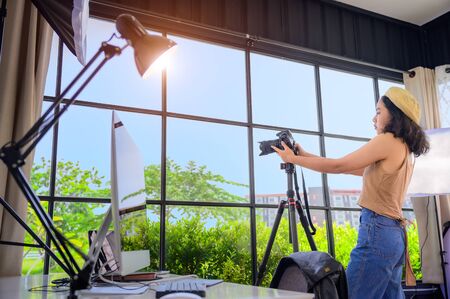 woman freelance photographer and blogger working individual at own office studioの写真素材