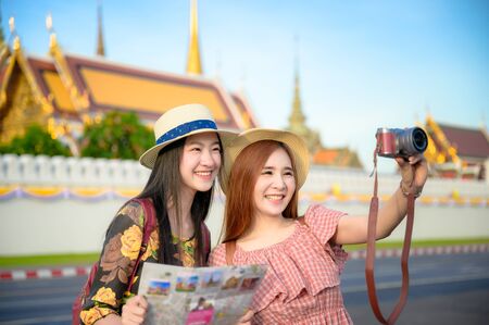 tourist women in taking picture during visit the palace temple in Bangkok of Thailand, Emerald Buddha Temple, Wat Phra Kaew, Bangkok Royal Palace popular tourist placeの写真素材