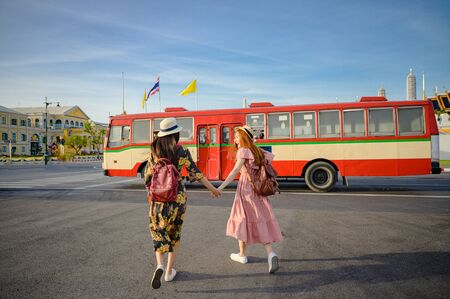 tourist women are going to get in Bus in Bangkok, traveling in urban bus city visit capital of...