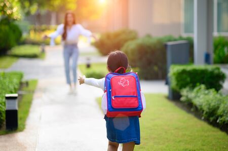 daughter back from school in the first day after study, mother welcome home and cheerfully of returning from school of daughter in backgroundの写真素材