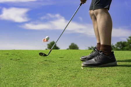 man golf player concentrate in hit the golf ball away to the destination green for winning in score...