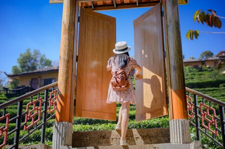 Woman  runs exciting to the stair opening doorの写真素材