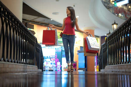 slim woman holding shopping bags satisfy and happy enjoy walks in mall department store on...