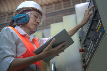 Woman engineering in charge of working duty in dashboard controller of the machine operation in...