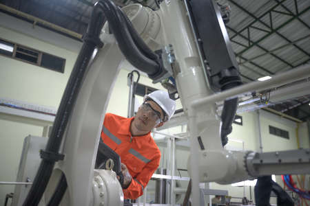 supervisor inspect or testing the system of robotic brand new in smart factory modern, working robotic machinery working together with human control in modern factoryの写真素材