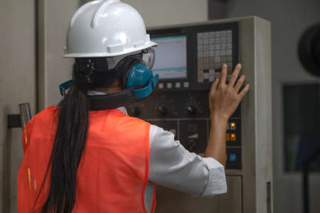Woman engineering in charge of working duty in dashboard controller of the machine operation in...