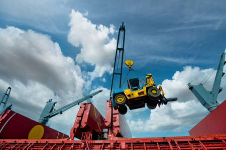 crane of the ship lifting machinery forklift for operation in the port terminal, lifting heavy unite prepare specialist handling operationの写真素材