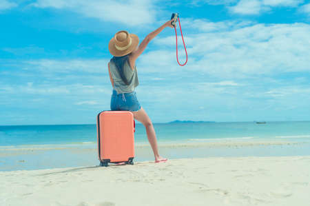 Woman tourist traveler in motion of enjoy and happiness freedom life on the sea beach of the island, long weekends holiday or vacation cheerfully freedom life occurrence after situation has gone, being travel as usual living lifeの写真素材
