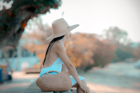 Woman sits in feel relax motion at the edge of the sea beach, summer vacation travelingの写真素材
