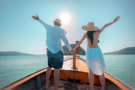Tourist in motion of enjoy trip of sailing longtailboat, summer vacation traveling together of coupleの写真素材