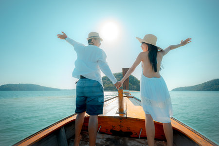 Tourist in motion of enjoy trip of sailing longtailboat, summer vacation traveling together of coupleの写真素材
