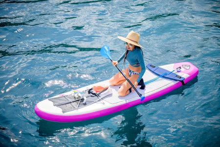 Woman tourist  paddle board at the sea summer, vacation long weekend traveling in islandの写真素材