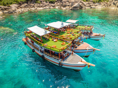 Top aerial view of natural bay serving traveler tourists. Tour boats are dropped at anchorage, letting people enjoy water sports together in summertime. Thailand travel and visiting.の写真素材