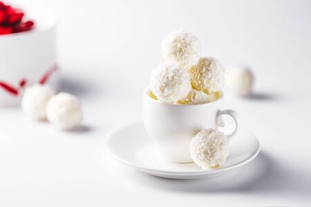 coconut candy in a tea cup on a white backgroundの写真素材