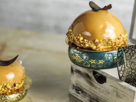 cakes in the form of an apple on a background of a white brick wall, jewelry and a casket in the frame.の写真素材