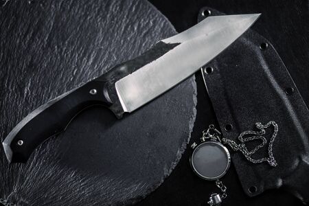all-metal, tactical, kitchen knife on a mirror surface, handwork, steel blade, blade forging marksの写真素材