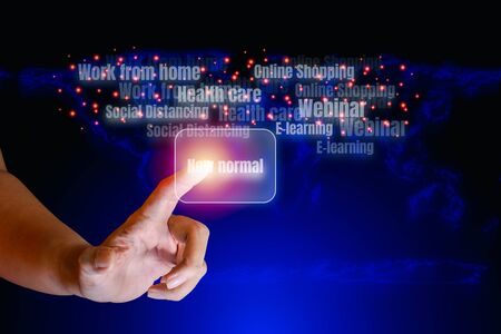 Finger point on the virtual screen of text 'New normal' and soft-focus blue world map on technology background, great changes in the world. New normal concept.の写真素材