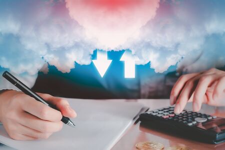 Cloud data storage concept. Double exposure businessman working in office with white cloud and arrow on blue sky background with copyspace. Communication of business and financial. Transfer data to storage.の写真素材