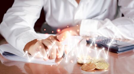 Business and analysis concept. Businessman touch on graph and analysis financial on virtual screen, positive growth of money and stock.の写真素材