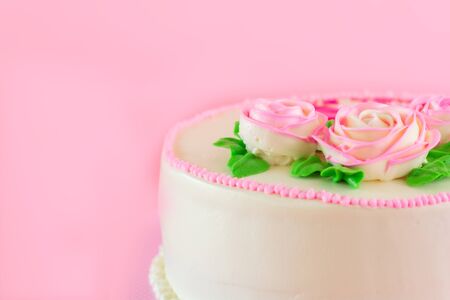 Butter cream of Pink Roses decorated oo vanilla pond cake on pink background with copy space served in Birthday Party and wedding. Delicious sweet bakery for someone you love.の写真素材