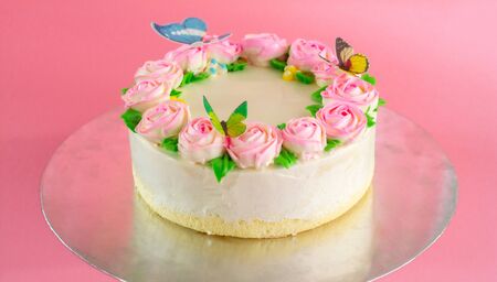 Butter cream of Pink Roses decorated oo vanilla pond cake on pink background with copy space served in Birthday Party and wedding. Delicious sweet bakery for someone you love.の写真素材