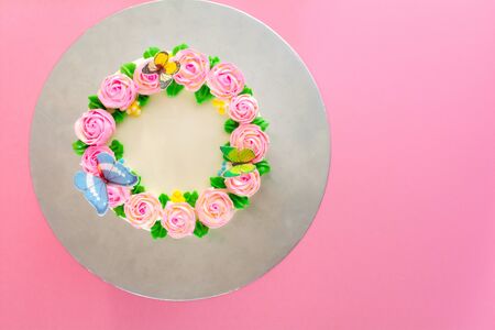 Butter cream of Pink Roses decorated oo vanilla pond cake on pink background with copy space served in Birthday Party and wedding. Delicious sweet bakery for someone you love.の写真素材