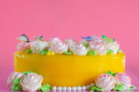 Butter cream of Pink Roses decorated on orange pond cake on pink background with copy space served in Birthday Party and wedding. Delicious sweet bakery for someone you love.の写真素材