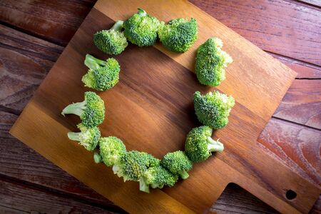 Top view broccoli on wooden chopping board with copy space for your text.の写真素材