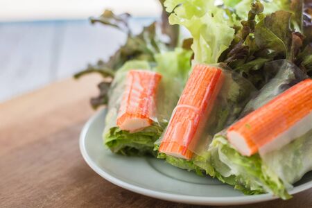 Crab stick in salad roll on white dish. Healthy food concept.の写真素材