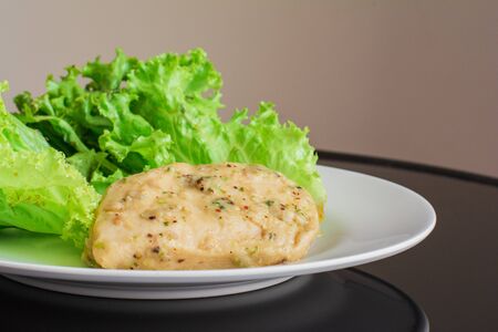 Chicken breast steak with spices serve with fresh green lettuce on white plate. High protein food. Healthy for loose weight.の写真素材