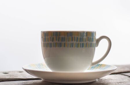 Hot coffee (espresso, cappuchino, latte) in ceramic white cup on wooden table with white background.の写真素材