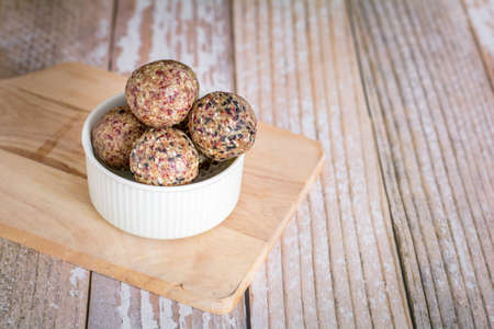 Healthy snack. Energy ball with date plam, black and white sesame, chia and rasin in ceramic palte...
