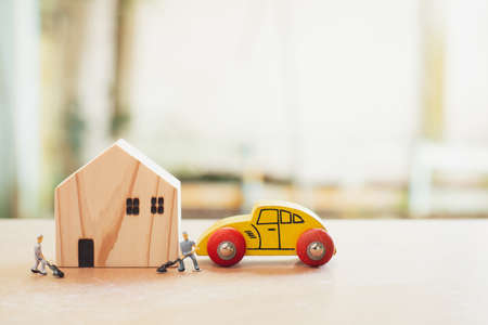 Home repair and inspector concept. Wooden home and blurry miniature or small technician fix and...