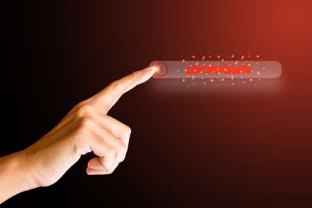 Finger touch on the red close button and lockdown word on dark background. Save life and prevent from virus.の写真素材