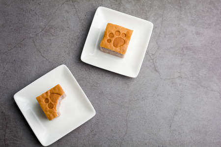 Top view a square-cut of sweet potato cake on a white plate in the kitchen. Bakery and beverage concept.の写真素材
