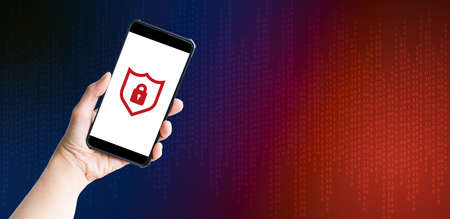 Cybercrime and hacker concepts. Hand-holding mobile or smartphone with red lock security and blue...
