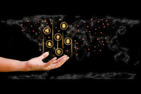 Business and technology concept. Hand-holding cryptocurrency coin and blockchain technology and world map background. Big data information exchanges digital currency and online payment.の写真素材